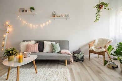 sofa, coffee table and wicker chair in living room styled scandinavian