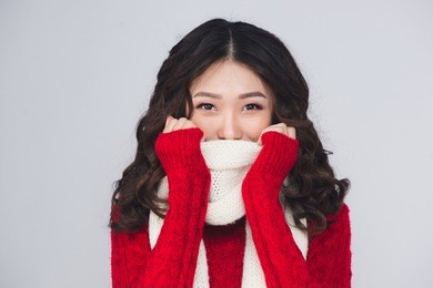 beautiful smiling fashion model face with red lips in warm clothing