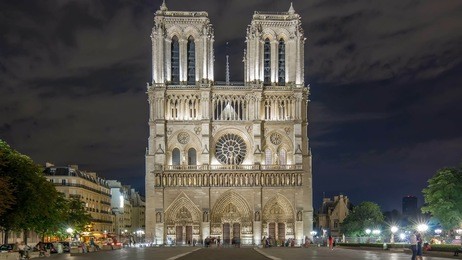 night view of illuminated notre dame de paris timelapse, france and square in front of the cathedral with people. front view with tilt-shift lens