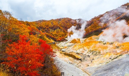 jigokudani hell valley in hokkaido, japan. hell valley in japanese is 'noboribetsu'. it is one of the famous tourist destination to visit. white heavy sulfur gas steaming from the ground smell bad.