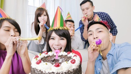 people smile happily with birthday party in the home