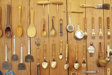 kitchenware hanging on wooden wall. selective focus.