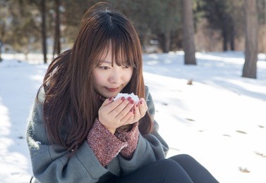 beautiful asian women playing in the snow