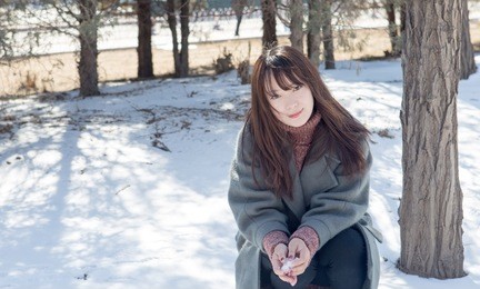 beautiful asian women playing in the snow
