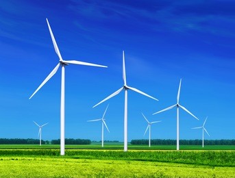 green meadow with wind turbines generating electricity