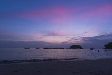 beautiful colored sky after sunset at kata beach, phuket, thailand