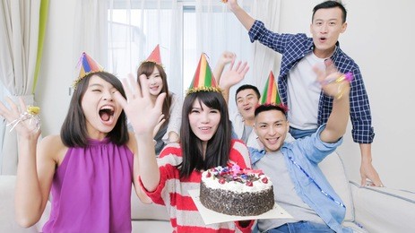 people smile happily with birthday party in the home