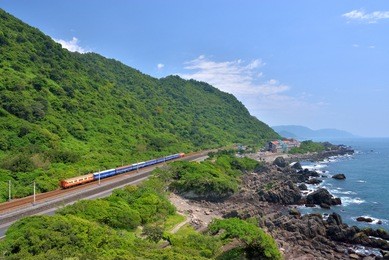 railway construction in the middle of the mountains and reefs on the northern coast of taiwan, there are fast trains and roads with cars next to them. ilan, taiwan.