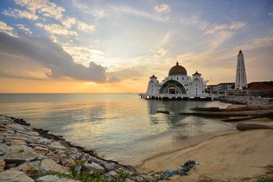 beautiful malacca straits mosque (masjid selat melaka) with beautiful sunset background. it is a mosque located on the man-made malacca island near malacca town, malaysia.
