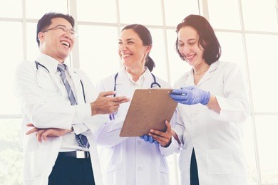multiethnic group of doctors and nurses or medical scientist meeting cooperating and discussing diagnose patient. happy asian doctors training with russian researcher trust in team is caes success