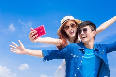 couple selfie happily with the blue sky