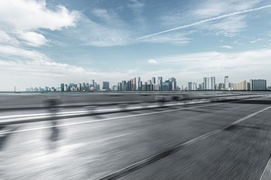 blurred urban traffic road with cityscape in background, china