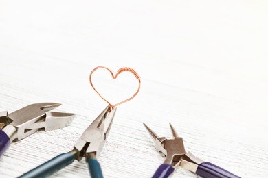jewelry tools. pliers, hammer and files on a blue background