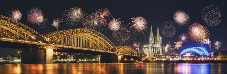 cologne cathedral and hohenzollern bridge with fireworks on new year day, cologne, germany