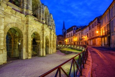 arles old town and roman amphitheatre, provence, france at late evening light