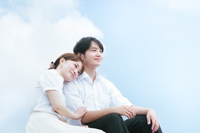 couple cuddling under the blue sky