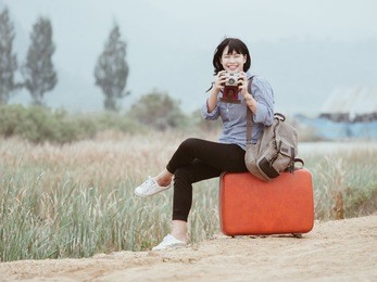 young asian beautiful woman traveling concept on the good view mountain and field vintage color