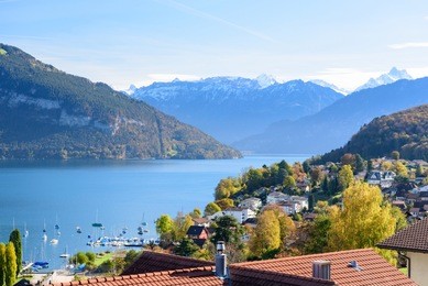 view of lake thun in switzerland during autumn season from spiez train station