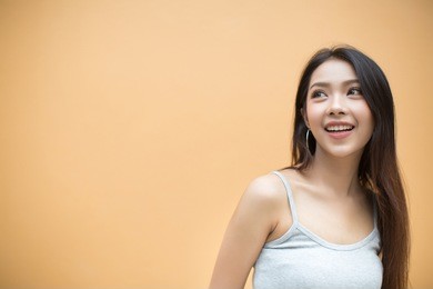 smiling woman on orange background