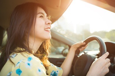 beautiful asian woman enjoying life  in the red car.