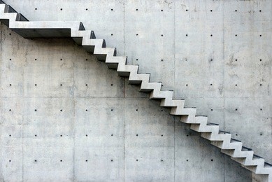 concrete staircase with concrete wall out of building - side view