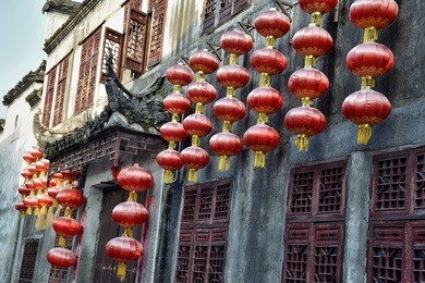facade of the old house decorated with red lanterns in xidi, a small ancient village in anhui province in china. 