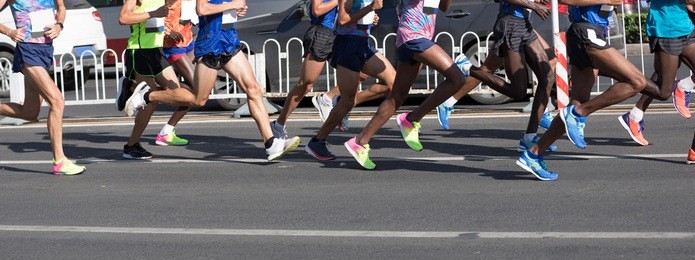 marathon runners legs running on city road