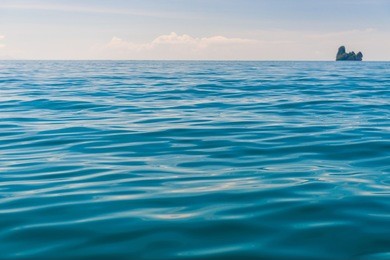 andaman sea, close-up water and an island on the horizon
