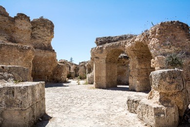 the arch in the stone wall of sandstone. ancient masonry. the ruins of carthage in tunisia
