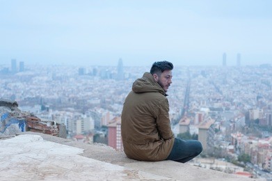 a man enjoys the view at the bunkers of el carmel, a famous spot in barcelona