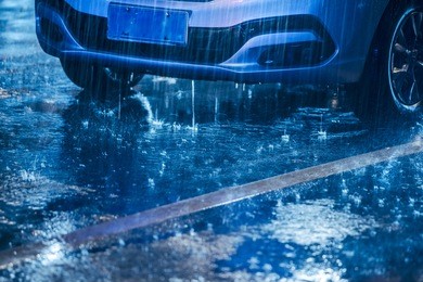 cars driving on wet road in the rain with headlights