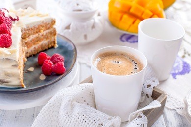 cut the cake with white cream, for breakfast. a mango fruit.