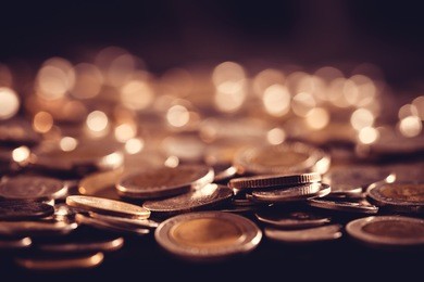 close up money coin on the floor in dark light , business and financial for money saving or investment background concept with black copy space , extremely close up and shallow dof