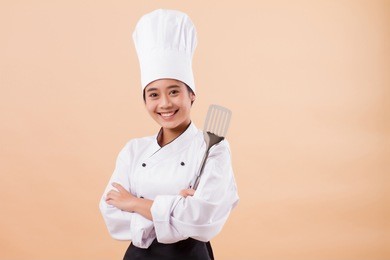 woman chef holding spatula cooking equipment