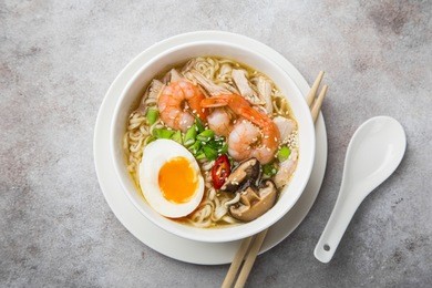 ramen noodle soup with prawn, shiitake mushroms and egg in white bowl, top view,