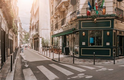 cozy street with tables of irish pub in paris, france