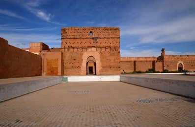 arabic palace called al-badi in marrakech, morocco, in the foreground empty swimming pool without water, sunny day, blue sky