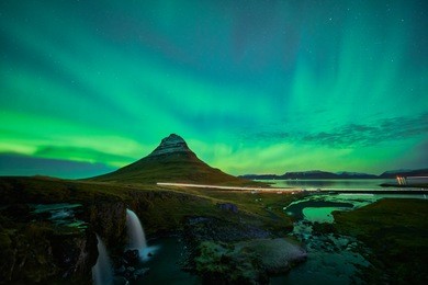 this beautiful northern lights or aurora borealis in iceland was taken at or around kirkjufell mountain and kirkjufellfoss near grundarfjordur during a winter night in november.  