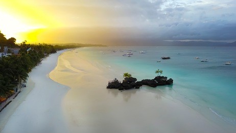 aerial image of the willy’s rock -an oddly shaped volcanic formation with a statue of the blessed virgin mary in bocaray, philippine islands. it is one of the most recognizable landmark of the island