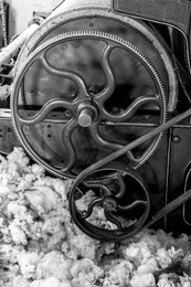 old 1900s woolen mill machinery and manufacturing with wool on the floor in black and white