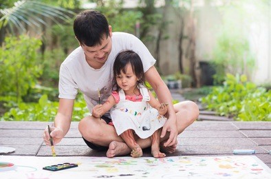 asian father and daughter are playing by color painting together with fully happiness moment, concept of learning activity for kid in family lifestyle