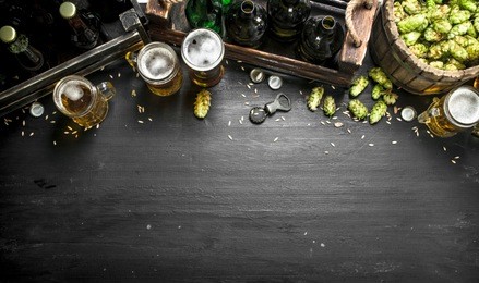 beer background. fresh beer and ingredients. on the black chalkboard.