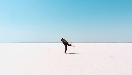 young man lifting the woman. enjoying couple on dry salt lake