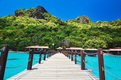 jetty to bohey dulang island in sabah, malaysia, one of a few islands in sabah made of volcanic rock. the island is famous for its clear crystal water, beautiful corals and scenic mountainous view