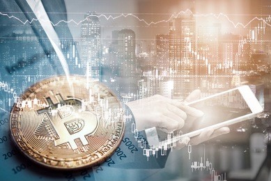 double exposure of businessman using tablet and city night background with bitcoin on graph report, bitcoin btc the new virtual electronic money. investment concept