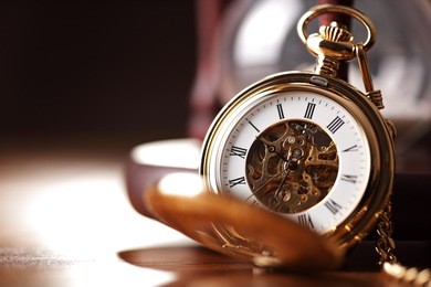 vintage pocket watch and hour glass or sand timer, symbols of time with copy space