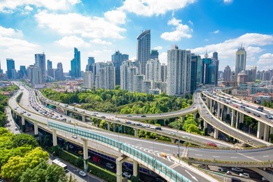 road junction and modern buildings in shanghai in blue cloud sky from high angle view