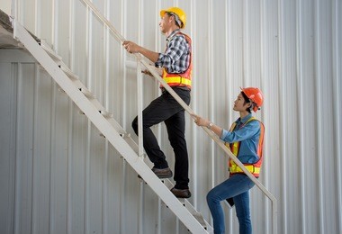 picture of professional asian engineering team wearing safety helmet go up the stairs at construction site