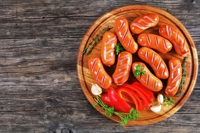 hot roasted juicy beef sausages with fresh thyme on round
