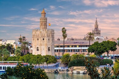 golden tower (torre del oro) at sunset from the other side of the guadalquivir river, seville (andalusia), spain.
